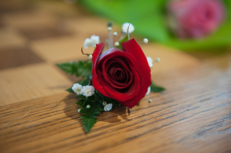 red rose boutonniere with baby's breath  from elope in st louis